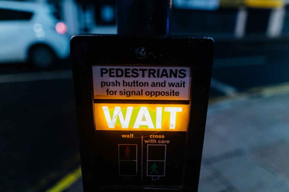 shallow focus photo of wait signage